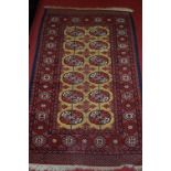 A Persian woollen Bokhara rug,