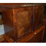 A 19th century flame mahogany double door table-top cupboard, w.