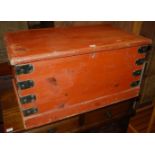 A 19th century stained pine and metal bound hinge top tool chest, having iron end carry handles,