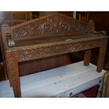 A late 19th century heavily carved oak two seater hall bench,