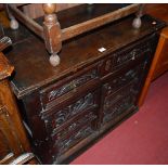 An antique joined and low carved oak double door side cupboard, having single upper drawer, w.