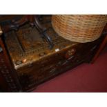A Chinese camphor wood hinged top blanket box, with typical relief carvings, w.