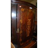 An 19th century mahogany and floral penwork decorated single door bowfront hanging corner cupboard