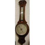 An early 20th century low relief carved oak aneroid two-dial wheel barometer