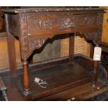 A low relief carved oak single drawer side table,