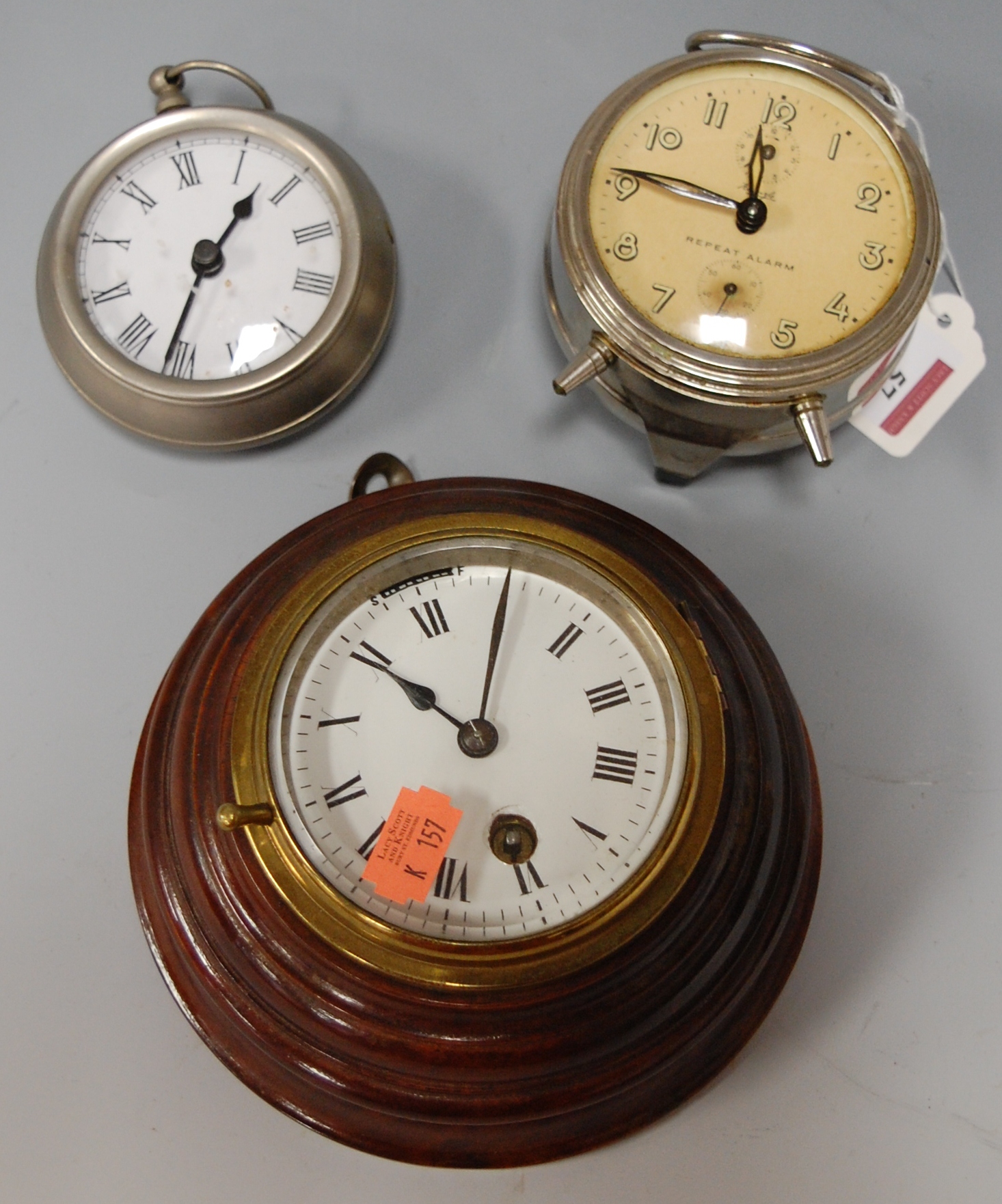 An early 20th century brass cased and mahogany mounted wall clock having enamel dial with Roman