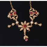 An Edwardian 18ct gold, ruby and seed pearl set necklet,