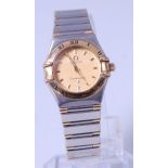 A ladies bi-metal Omega Constellation bracelet watch, having signed gilded dial with baton markers,