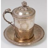 A Persian silver tankard and cover, having floral cast finial to further conforming handle,