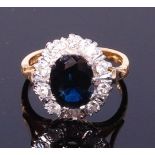 An 18ct gold, sapphire and diamond cluster ring,