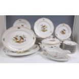 A Meissen porcelain dinner service, decorated with European birds and insects,