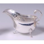 A Garrard & Co silver cream jug, having floral scroll handle,