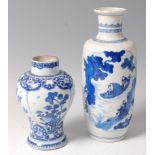 *A Chinese Kangxi period blue and white vase, of baluster form, decorated with reserves of flowers,