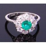 A platinum, emerald and diamond flower head cluster ring,