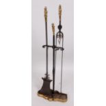 A Victorian wrought iron and brass mounted three-piece companion set,