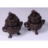 A pair of Japanese Meiji period bronze twin handled koro and covers,