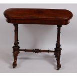 A Victorian walnut card table, the rectangular fold-over top revealing baize lined playing surface,