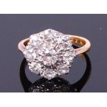 An 18ct gold diamond flower head cluster ring, arranged as nine old cut diamonds,