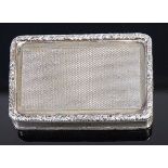 A George III silver pill-box, having a raised floral engraved border,