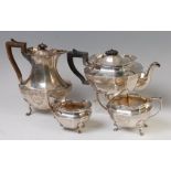 A George V silver four-piece tea and coffee set, comprising coffee pot and cover, teapot and cover,
