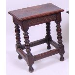 *A circa 1700 oak joint stool, the top having a moulded edge and carved frieze,