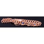 A 9ct gold curblink bracelet, set with single round cut sapphire and two old cut diamonds,