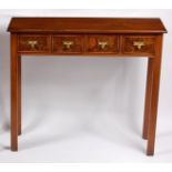 A mahogany and flame mahogany four drawer side table, the brass plate handles annotated 'Ginger',