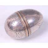 A George III silver novelty egg shaped nutmeg grater, having foliate engraved decoration,