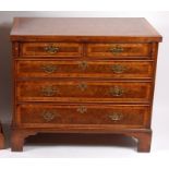 A large mid-18th century style figured walnut feather and cross banded bachelors chest,
