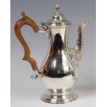 A George III silver pedestal coffee pot, of pear shape, having finial topped domed hinge cover,
