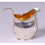 A George III silver helmet shaped cream jug,