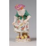 A Meissen porcelain figure 'Girl feeding Chickens',