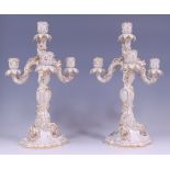 A pair of Meissen porcelain blanc-de-chine and parcel gilt decorated four light candelabra,