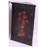 *An 18th century chinoiserie black lacquered hanging corner cupboard,