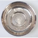 A Persian white metal circular table bowl, having stylised floral engraved decoration,