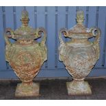 A pair of large cast iron pedestal garden urns and covers,