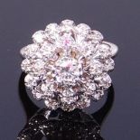 A 14ct white gold diamond cluster ring, arranged as three graduated tiers of claw set brilliants,