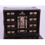 *An 18th century Continental ebony, calamander and penwork ivory decorated table cabinet,