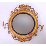 *A 19th century giltwood and gesso convex wall mirror, of good size,