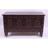 *An early 18th century joined oak and later carved four-panel mule chest,