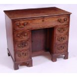 *A George III mahogany kneehole writing desk,