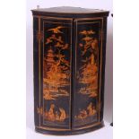 *An 18th century chinoiserie black lacquered bowfront hanging corner cupboard,