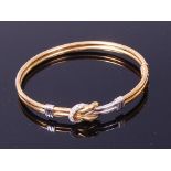 An 18ct gold diamond set hinge bangle,