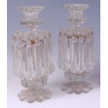 *A pair of late 19th century cut clear glass pedestal lustres,