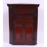 *An 18th century joined oak hanging corner cupboard,