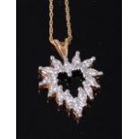 A modern 14ct gold and diamond set pendant, of heart shape, total diamond weight estimated at 0.