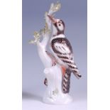 A Meissen porcelain model of a woodpecker upon a treestump, with attendant beetle,