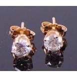 A pair of 14ct gold diamond ear studs, the four claw set brilliants each weighing approx 0.