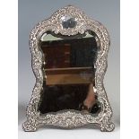 A late Victorian embossed silver mounted easel dressing table mirror,