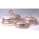 *A graduated set of seven Victorian silver plated meat covers, each of domed form with shell,